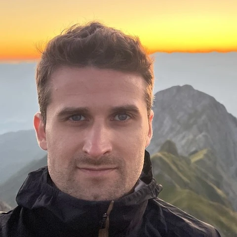 Roberto Popitanu on a mountain ridge at sunset.