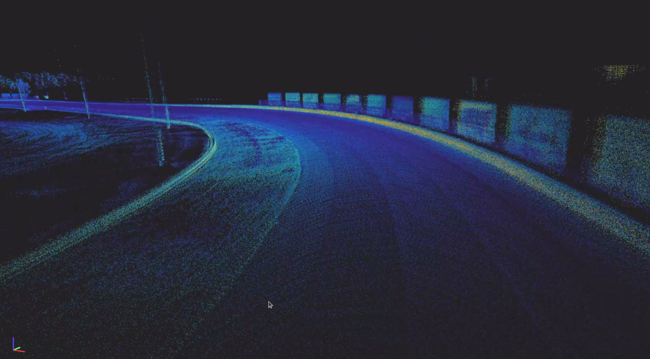 LiDAR point cloud of a racetrack corner showing the road surface, track boundaries, and safety barriers.