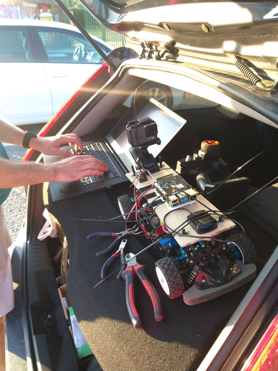 The instrumented four-wheel rover positioned on an athletics track for an outdoor localization test.